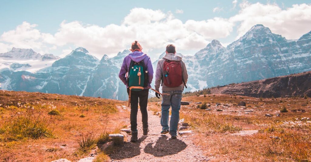 Two hikers walking on a scenic trail in Banff National Park, Alberta.